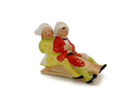 Antique Hertwig German Bisque Porcelain Sledding Figurine